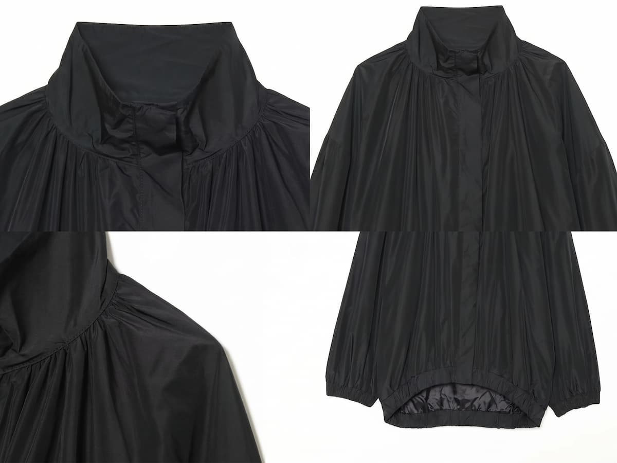 Detalle del dobladillo, costuras y acabado de Chaqueta estilo bomber negra de corte oversized con cuello alto alzado, cierre de cremallera frontal y mangas largas abullonadas con puños elásticos, fabricada en tejido ligero de poliéster para un look urbano y casual.