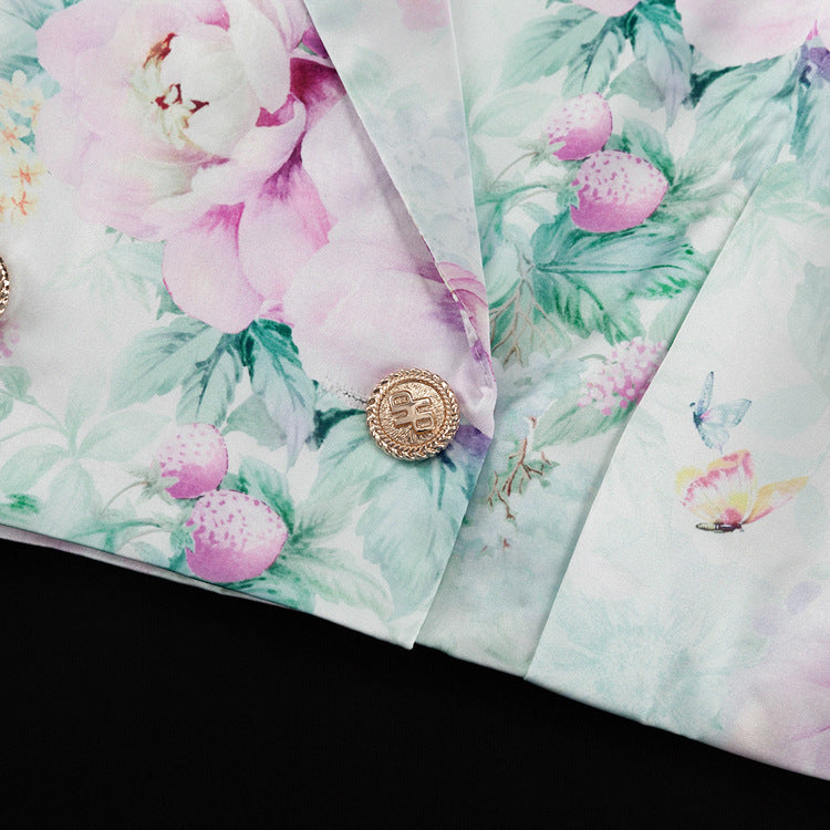 Detalle del dobladillo, costuras y acabado de conjunto de dos piezas floral en tonos rosa y pastel: blazer corto cropped de manga larga con solapas y botones frontales combinado con falda-pantalón mini de tiro alto a juego