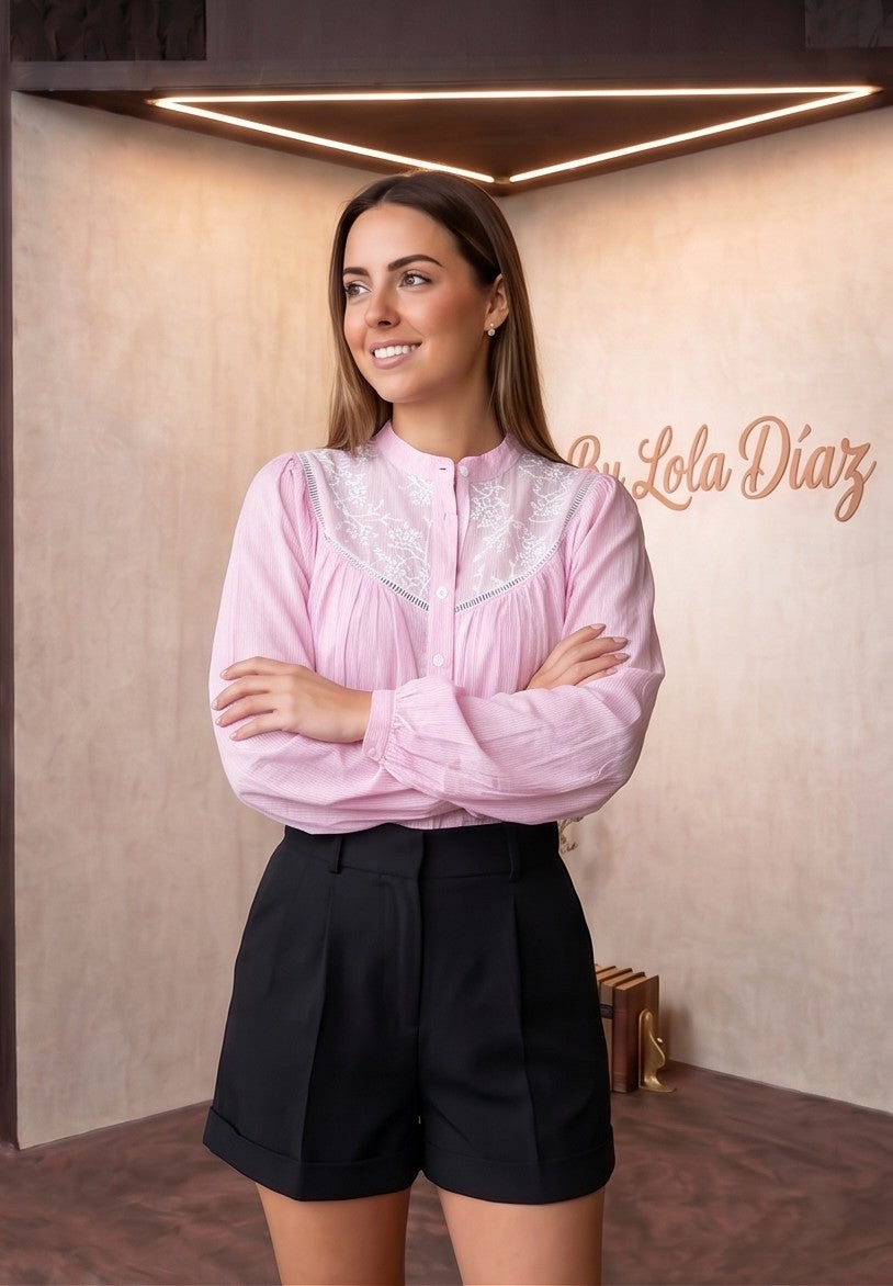 Blusa rosa claro para mujer con estampado fino de rayas diplomáticas, pechera y espalda con bordado floral blanco calado y cuello mao con botones frontales.