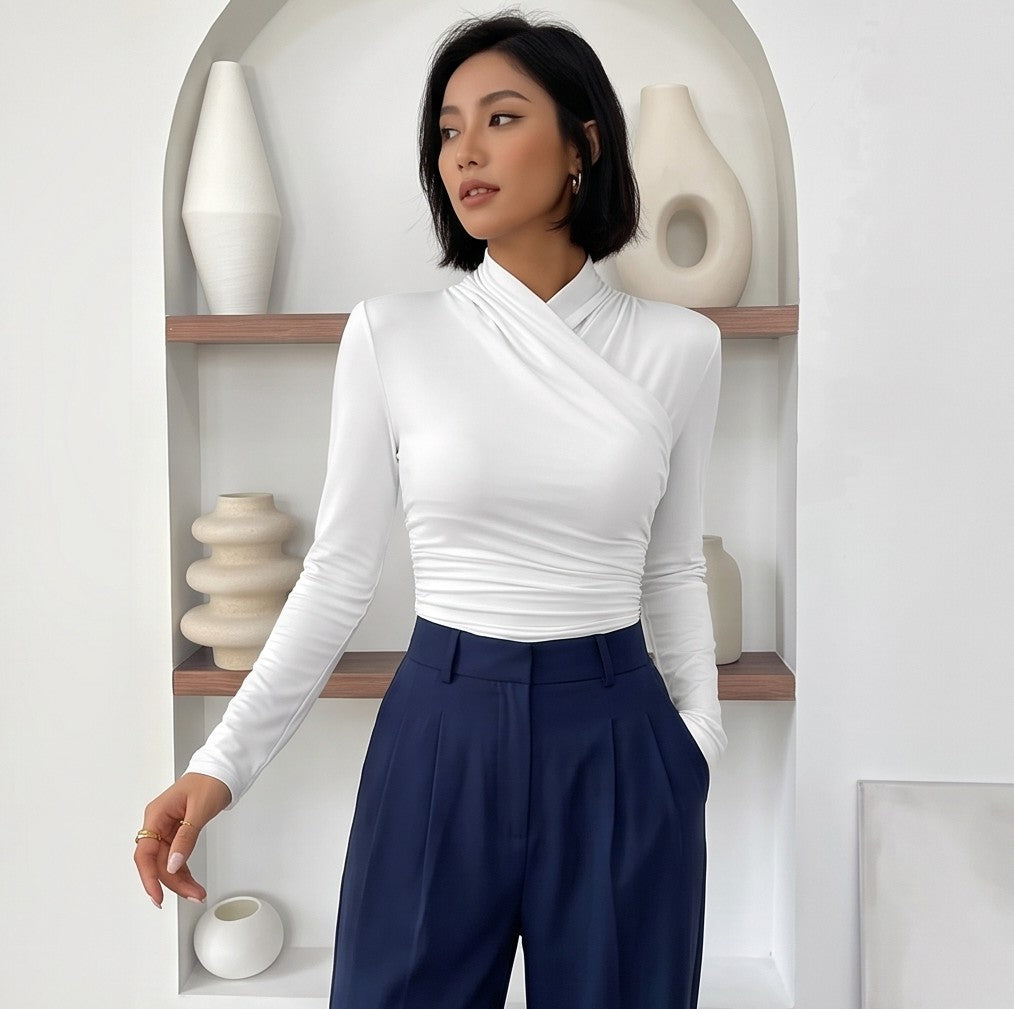 Camiseta ajustada de manga larga para mujer con cuello alto cruzado y detalle de fruncido lateral, disponible en tonos burdeos, azul oscuro, verde, rojo, negro, blanco, marrón y beige.