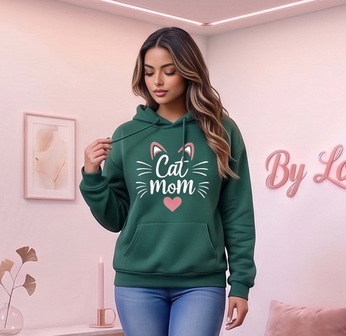 Sudadera hoodie con capucha de mujer corte holgado con estampado Cat Mom, orejitas de gato y corazón central. Diseño casual con bolsillo canguro delantero y mangas largas abullonadas, disponible en 8 colores: rosa, blanco, negro, gris jaspeado, marrón café, verde oscuro, albaricoque y morado